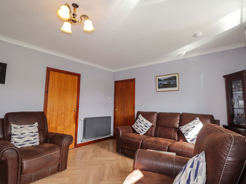 A living room with two armchairs and a sofa at The Highlander in Dornie