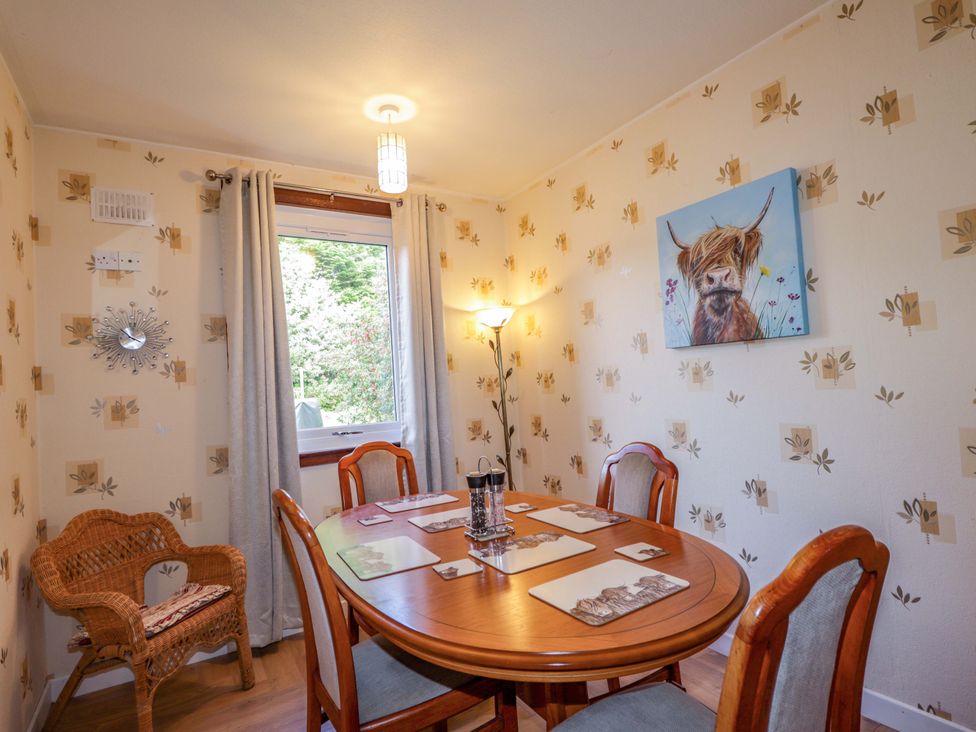 A dining room with a table and chairs at The Highlander in Dornie