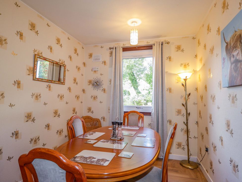 A dining room with a table and chairs at The Highlander in Dornie