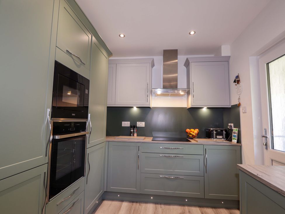 A kitchen with cabinets, oven, microwave, and extractor at The Highlander in Dornie