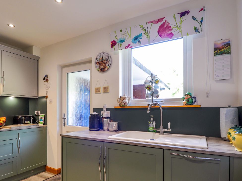 A kitchen with cabinets and a sink at The Highlander in Dornie
