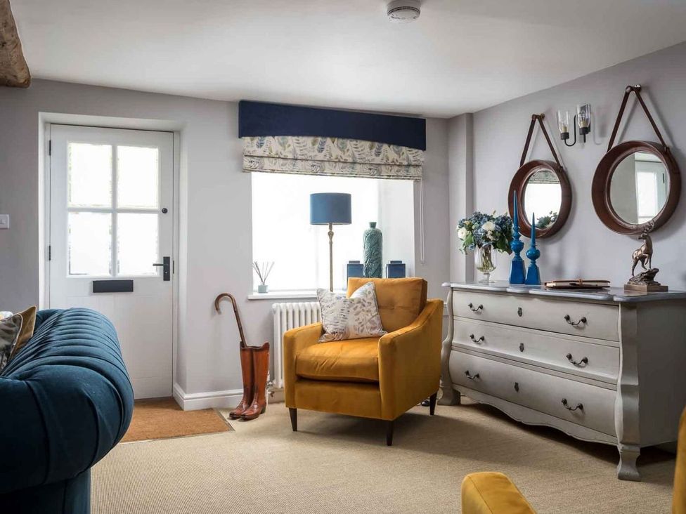 A living room featuring a yellow chair and a window at Lavender Cottage (Stow-on-the-Wold) Cheltenham
