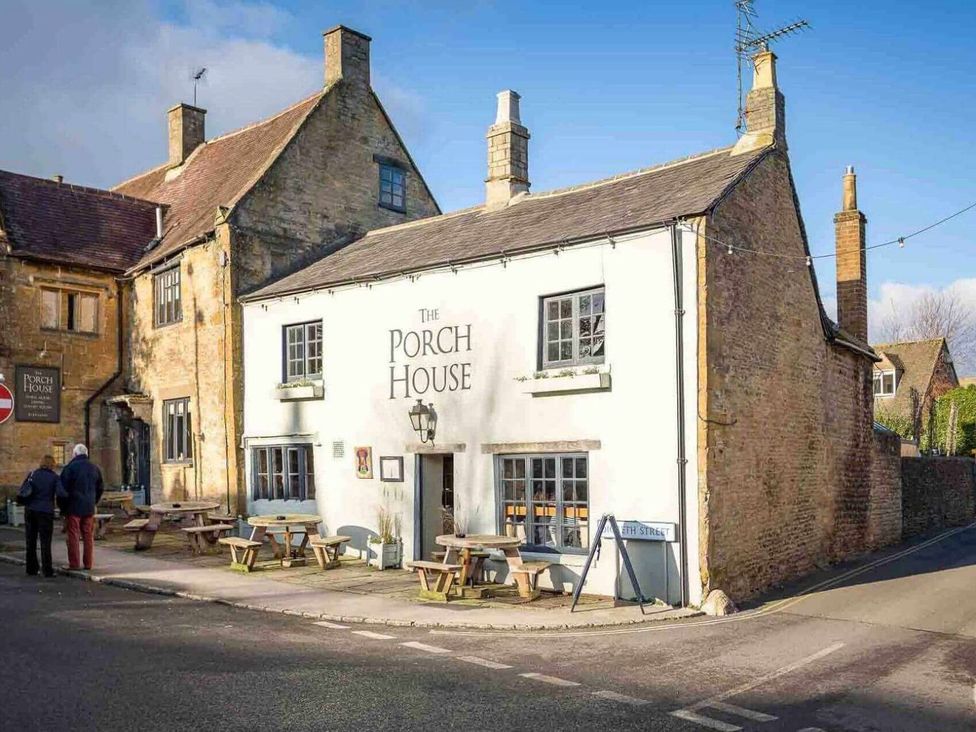 A building with tables and chairs outside at The Porch House in Cheltenham