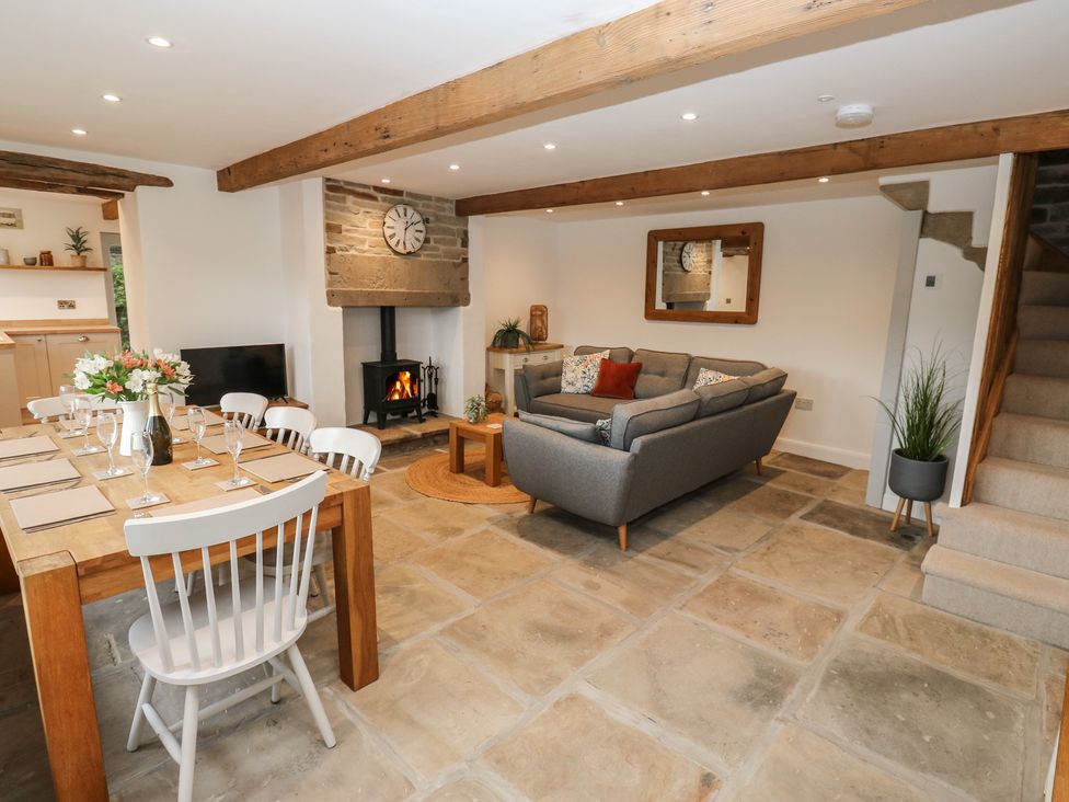 A dining area with a table and chairs at 6 Well Hill Holmfirth