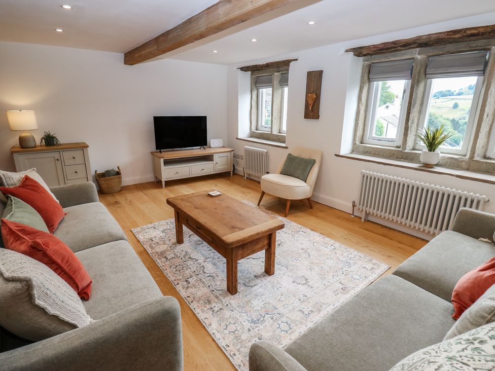 A living room with a sofa and coffee table at 6 Well Hill in Holmfirth
