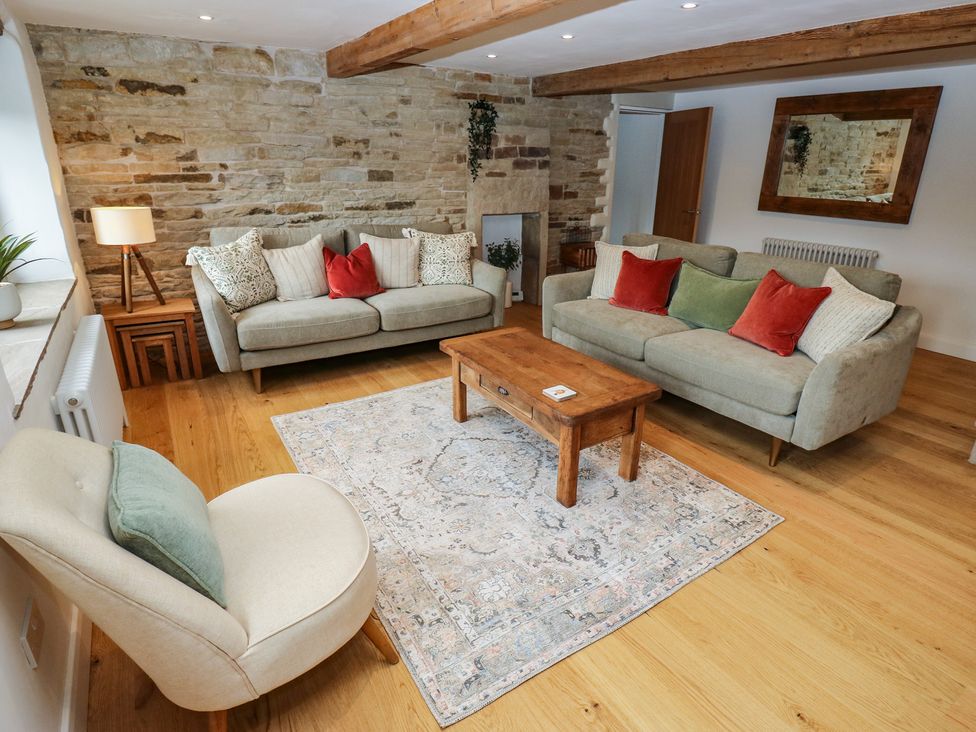 A living room with two sofas and an armchair at 6 Well Hill Holmfirth