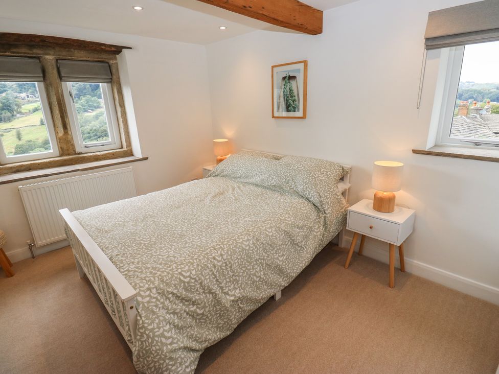 A bedroom with a bed and bedside table at 6 Well Hill in Holmfirth