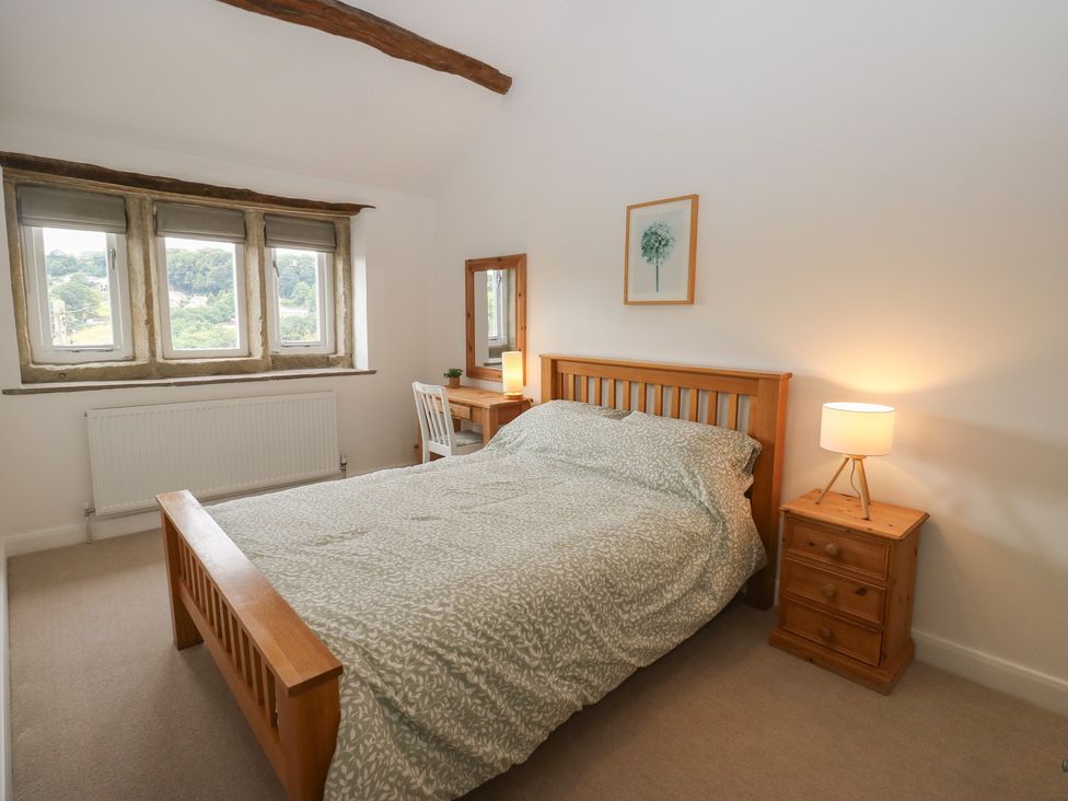 A bedroom with a bed and desk at 6 Well Hill in Holmfirth
