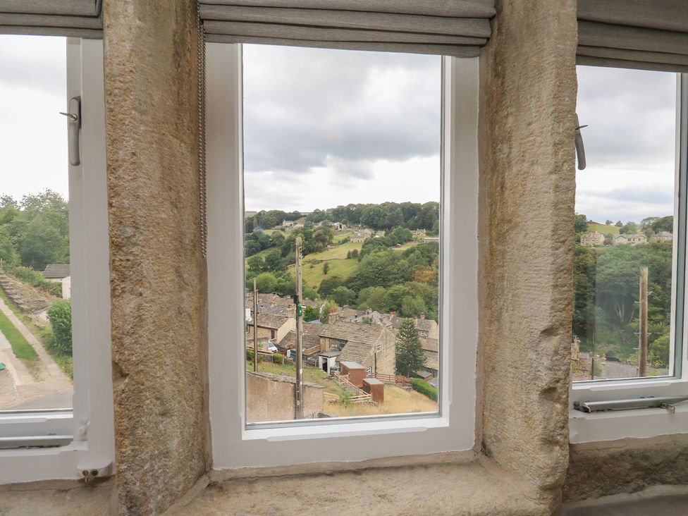 A window with a view of a village landscape at 6 Well Hill Holmfirth