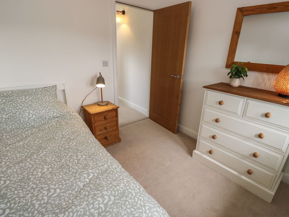 A bedroom with a bed and dresser at 6 Well Hill in Holmfirth