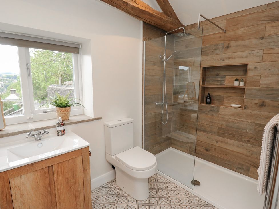 A bathroom with a sink and shower enclosure at 6 Well Hill Holmfirth