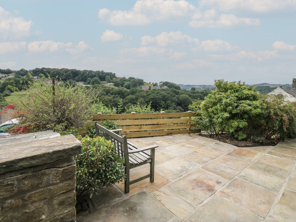 A garden with a bench and plants at 6 Well Hill in Holmfirth