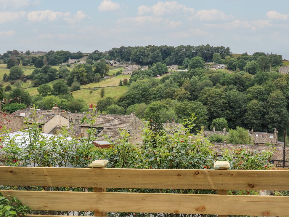 A scenic view of houses and trees from a hill at 6 Well Hill in Holmfirth