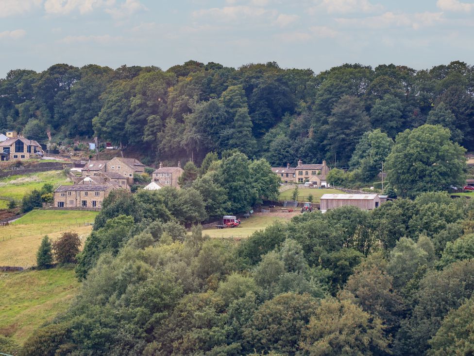 A landscape with houses and trees at 6 Well Hill Holmfirth