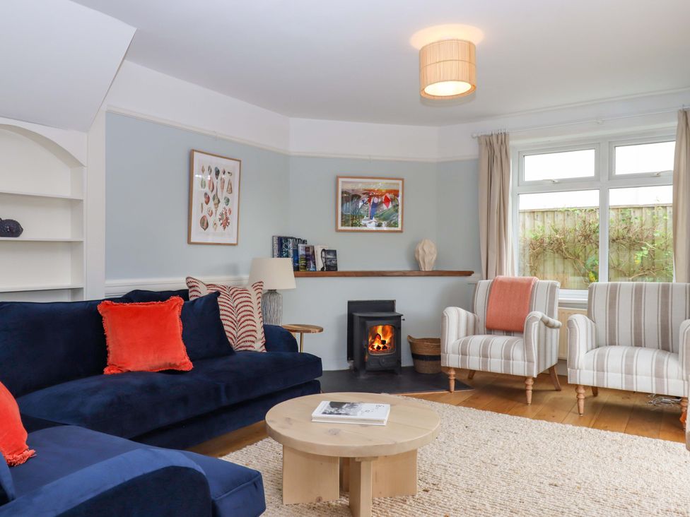 A living room with a sofa and armchairs at The Porthole in Newton Ferrers