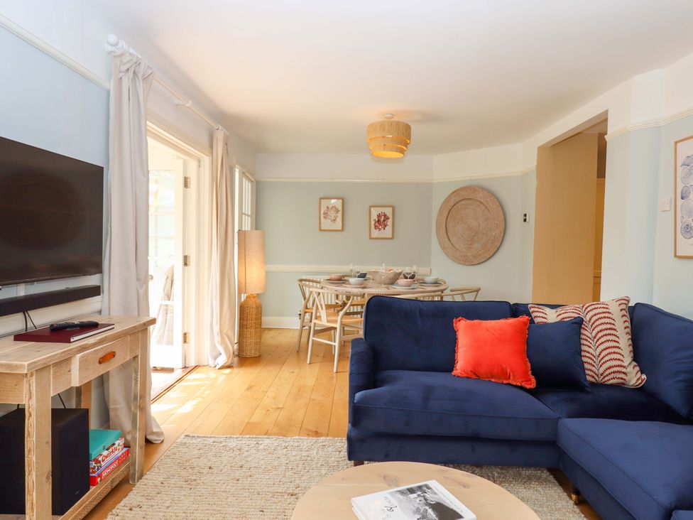 A living room with a sofa and television at The Porthole in Newton Ferrers