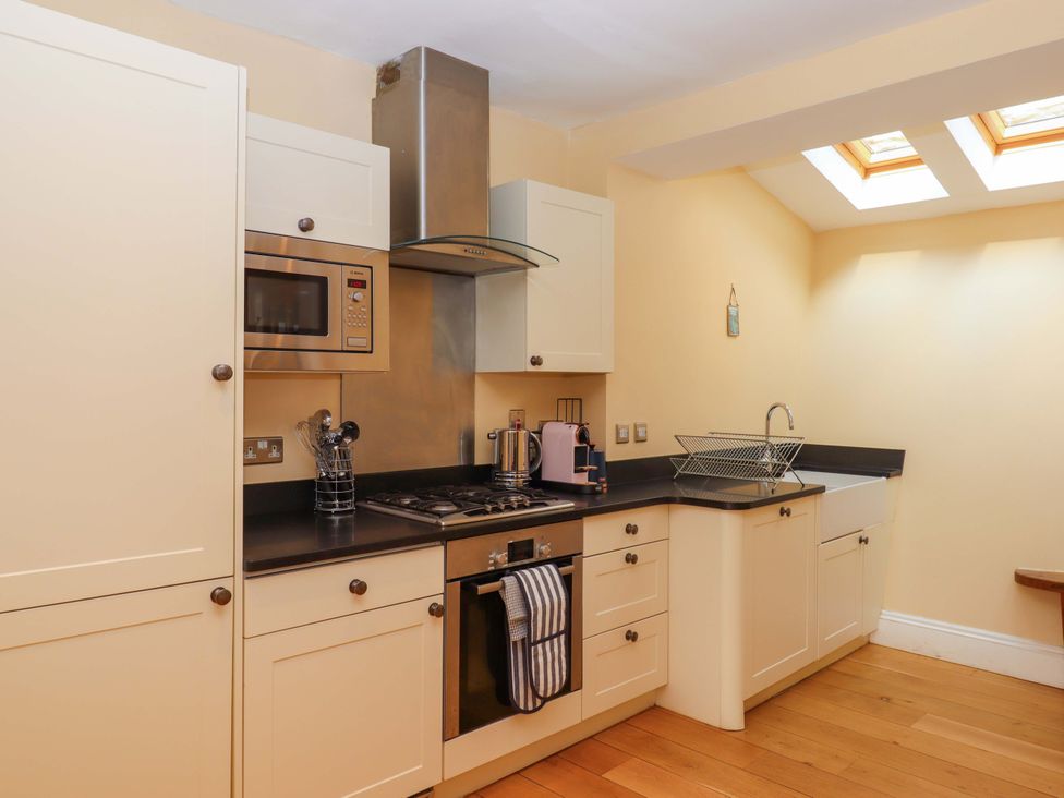 A kitchen with a sink and stovetop at The Porthole in Newton Ferrers