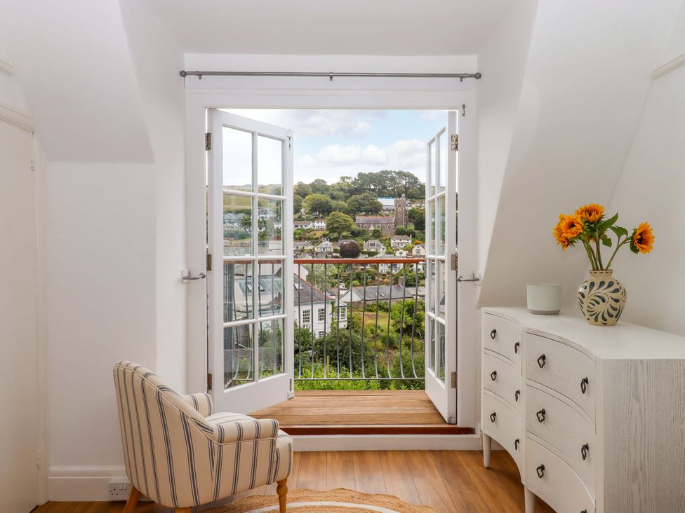 A room with double doors opening to a view at The Porthole in Newton Ferrers