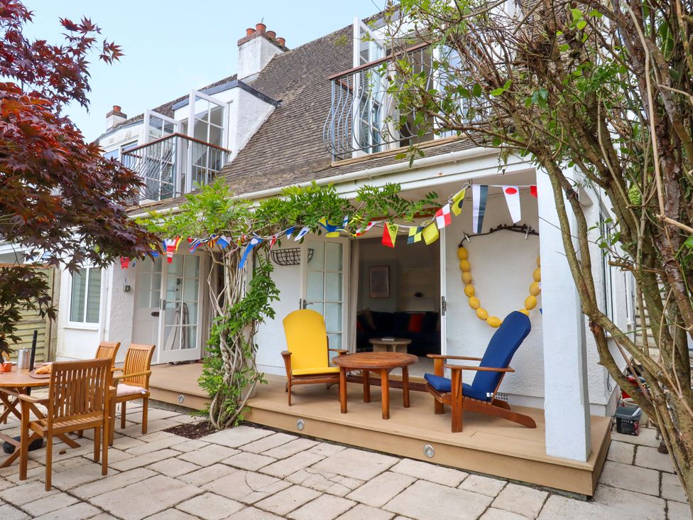 An outdoor area with seating and decorations at The Porthole in Newton Ferrers