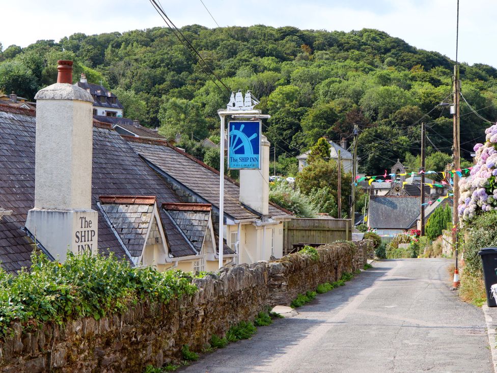 A view of The Ship Inn along a road in Newton Ferrers