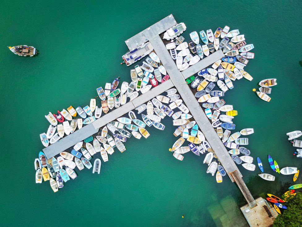 An aerial view of a dock with numerous boats at The Porthole in Newton Ferrers