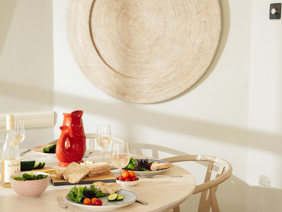 A dining room table set with food and drinks at The Porthole in Newton Ferrers