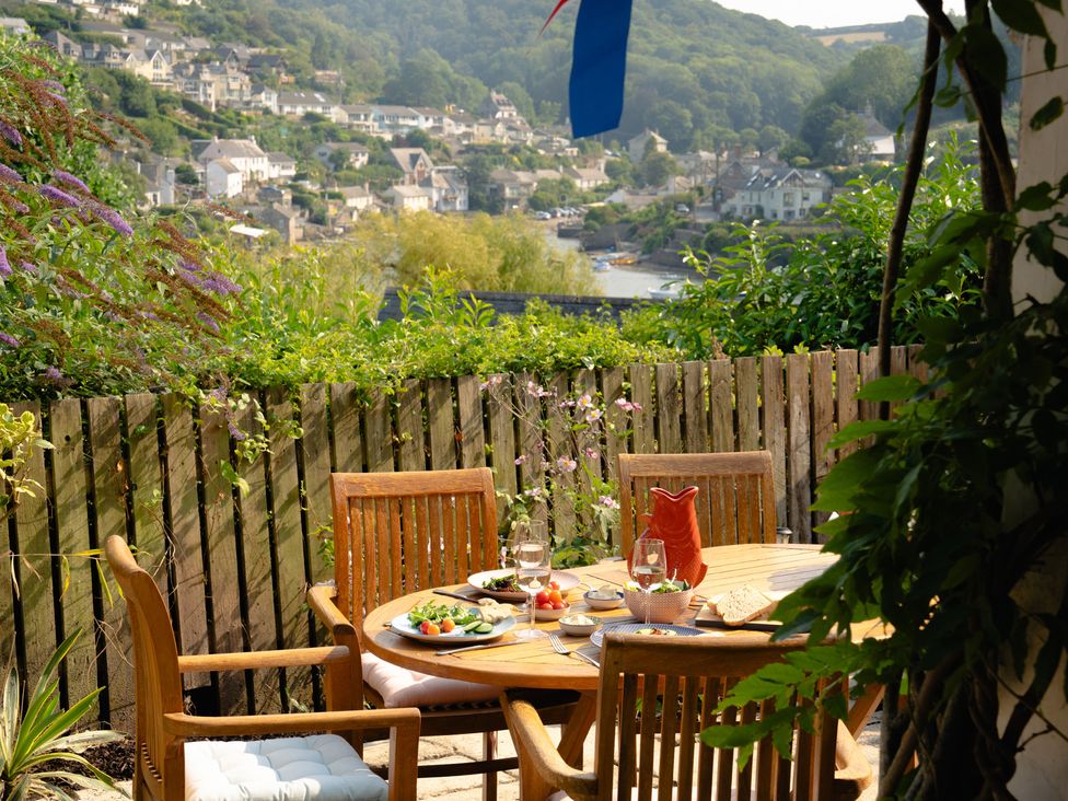 An outdoor dining area with a table and chairs at The Porthole Newton Ferrers