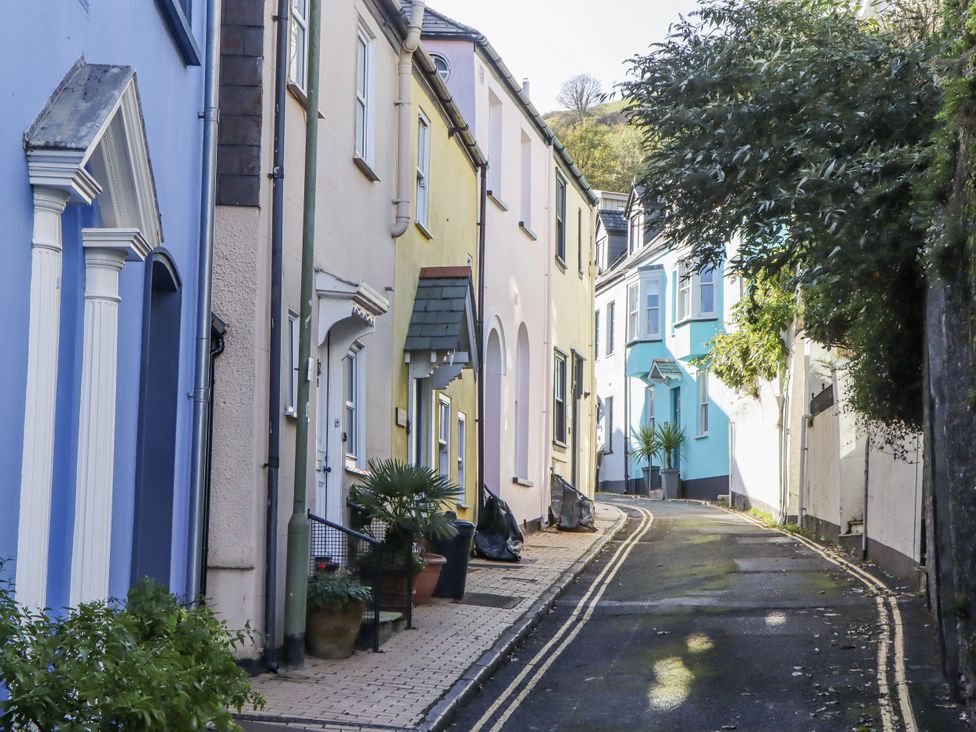 A street with colorful houses and a plant pot at 26 Above Town in Dartmouth