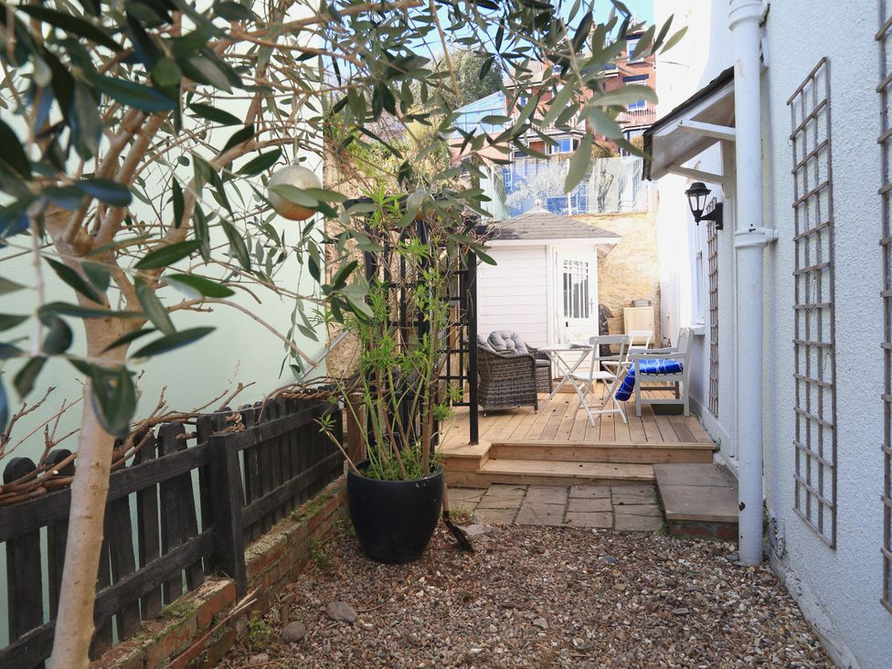 A garden with decking, furniture, and plants at 26 Above Town in Dartmouth