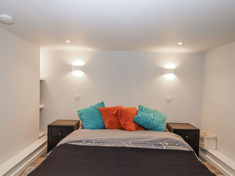 A bedroom with a bed and nightstands at 26 Above Town in Dartmouth