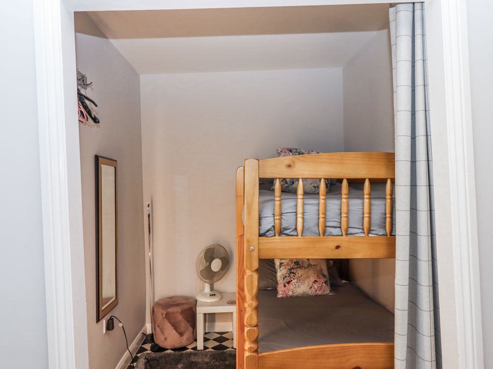 A bedroom with a bunk bed and a fan at 26 Above Town Dartmouth