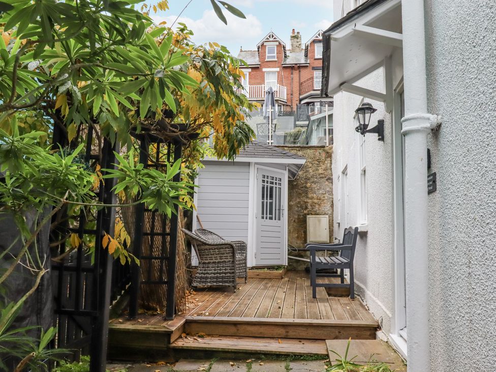 A garden with wooden decking and a shed at 26 Above Town, Dartmouth