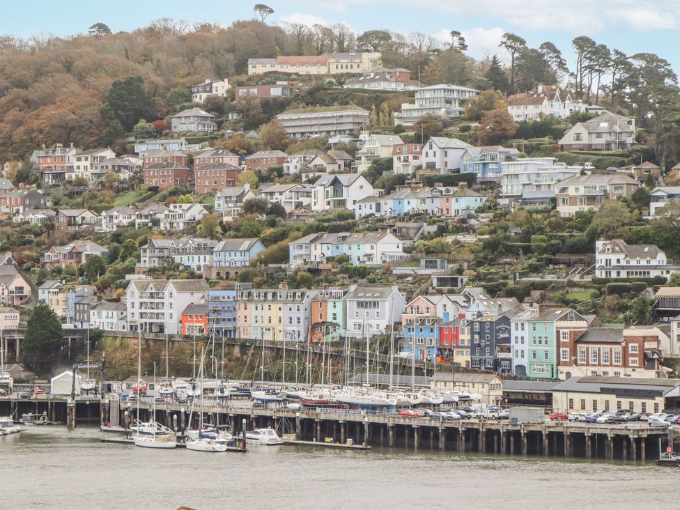 A view of colorful houses on a hill by the marina at 26 Above Town in Dartmouth