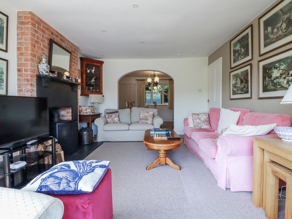 A living room with a sofa and a fireplace at Kiln Cottage Golant near Tywardreath