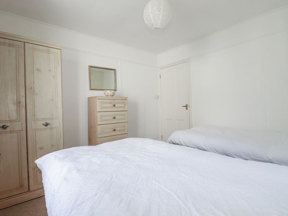 A bedroom with a bed and furniture at Kiln Cottage Golant near Tywardreath