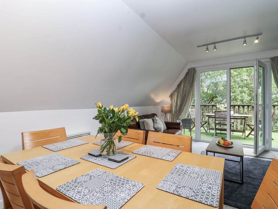 A dining room with a table and chairs at Valley Lodge 20 in Callington