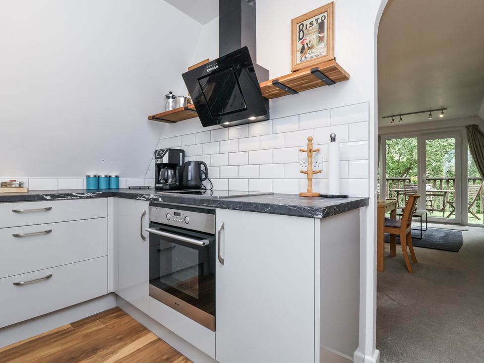 A kitchen with an oven and coffee maker at Valley Lodge 20 in Callington