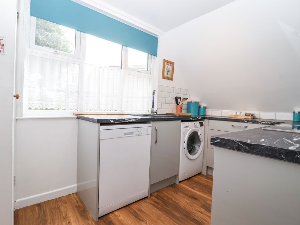 A kitchen with appliances and a countertop at Valley Lodge 20 in Callington