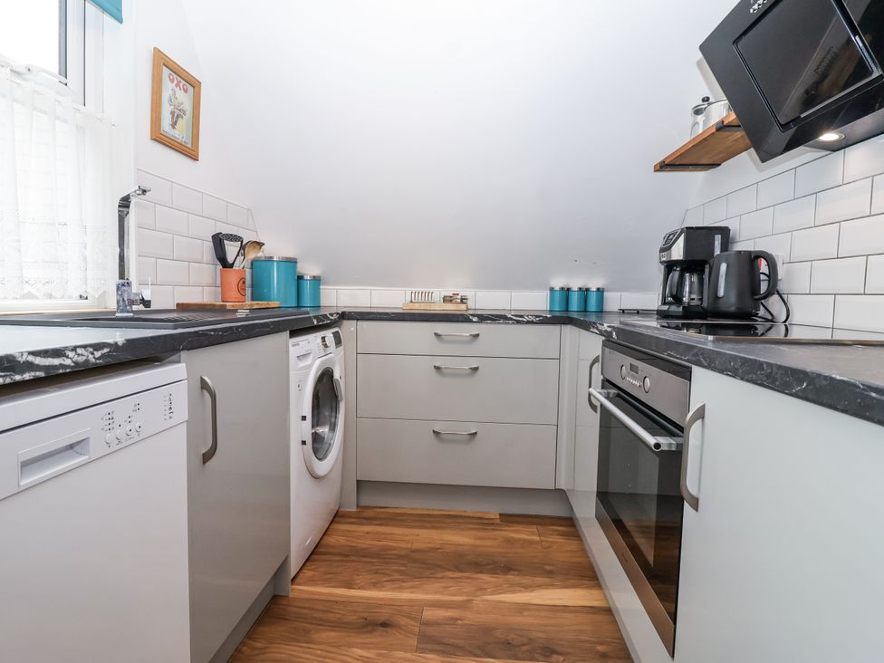 A kitchen with appliances and cabinets at Valley Lodge 20 Callington