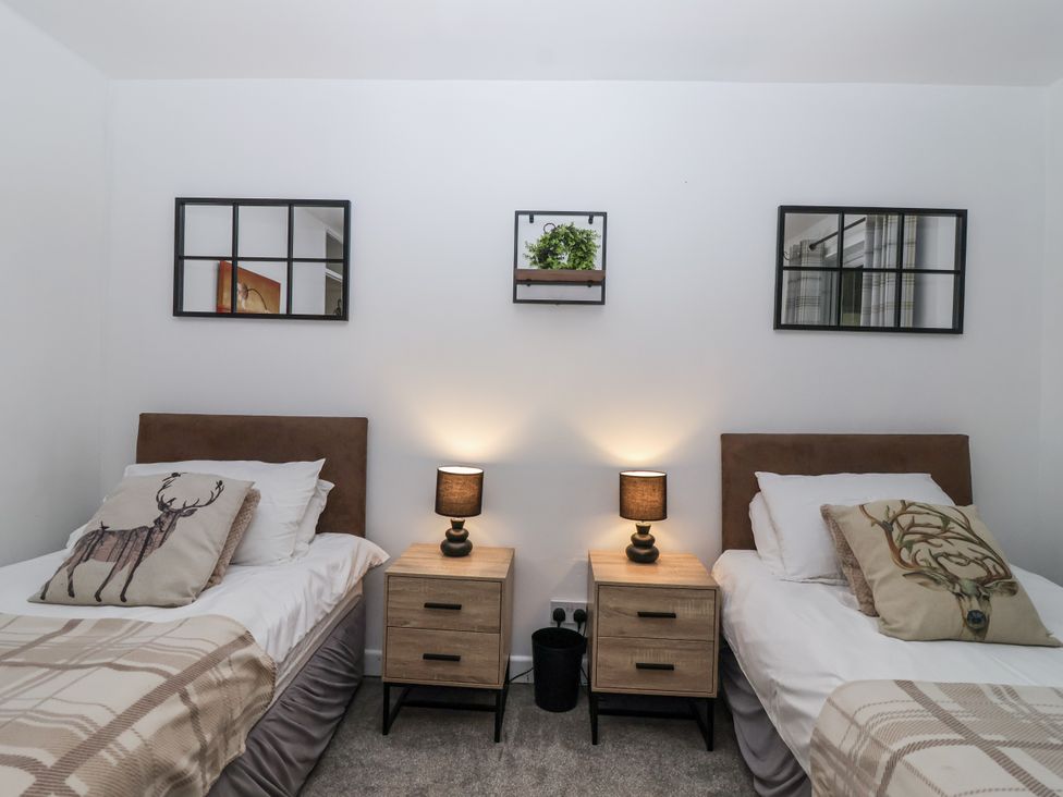 A bedroom with two beds and nightstands at Valley Lodge 20 Callington