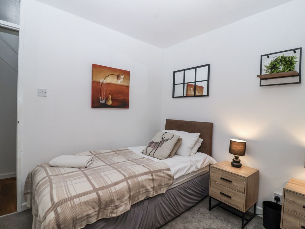 A bedroom with a bed and nightstand at Valley Lodge 20 in Callington