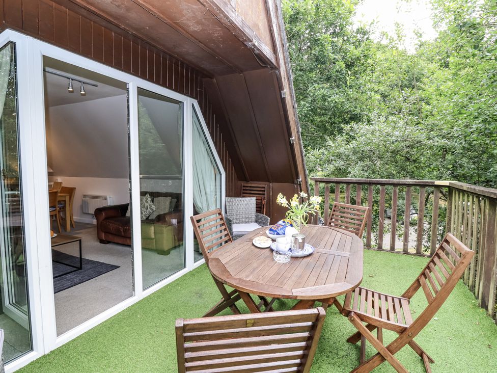 An outdoor seating area with a table and chairs at Valley Lodge 20 Callington