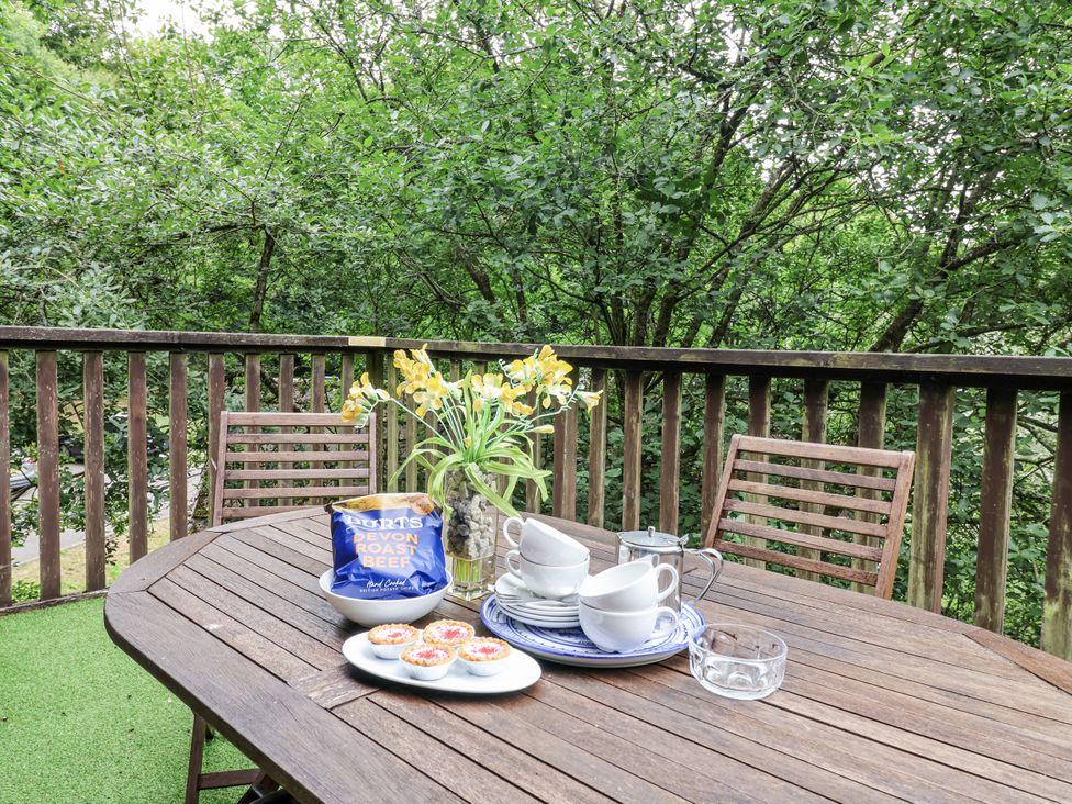 An outdoor dining area with a table set for snacks at Valley Lodge 20 Callington