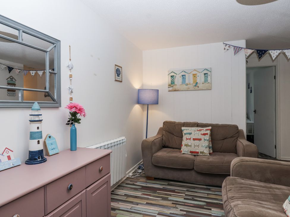 A living room with a sofa and decorative objects at Manorcombe 21 Honicombe Holiday Village near Gunnislake