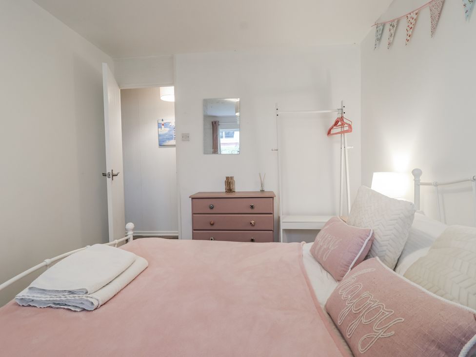 A bedroom with a bed and dresser at Manorcombe 21 in Honicombe Holiday Village near Gunnislake