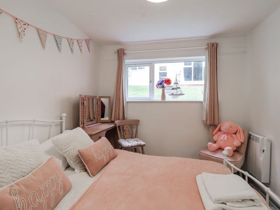 A bedroom with a bed and a window at Manorcombe 21 Honicombe Holiday Village near Gunnislake