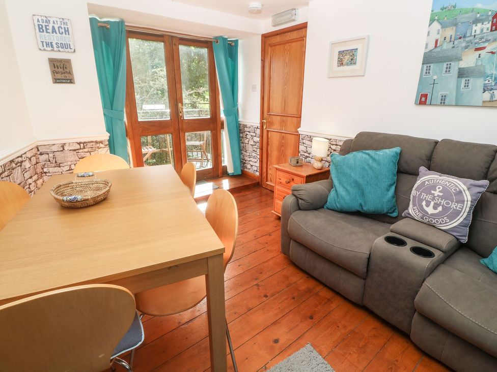 A dining room with a table and chairs at Mill House Barn 