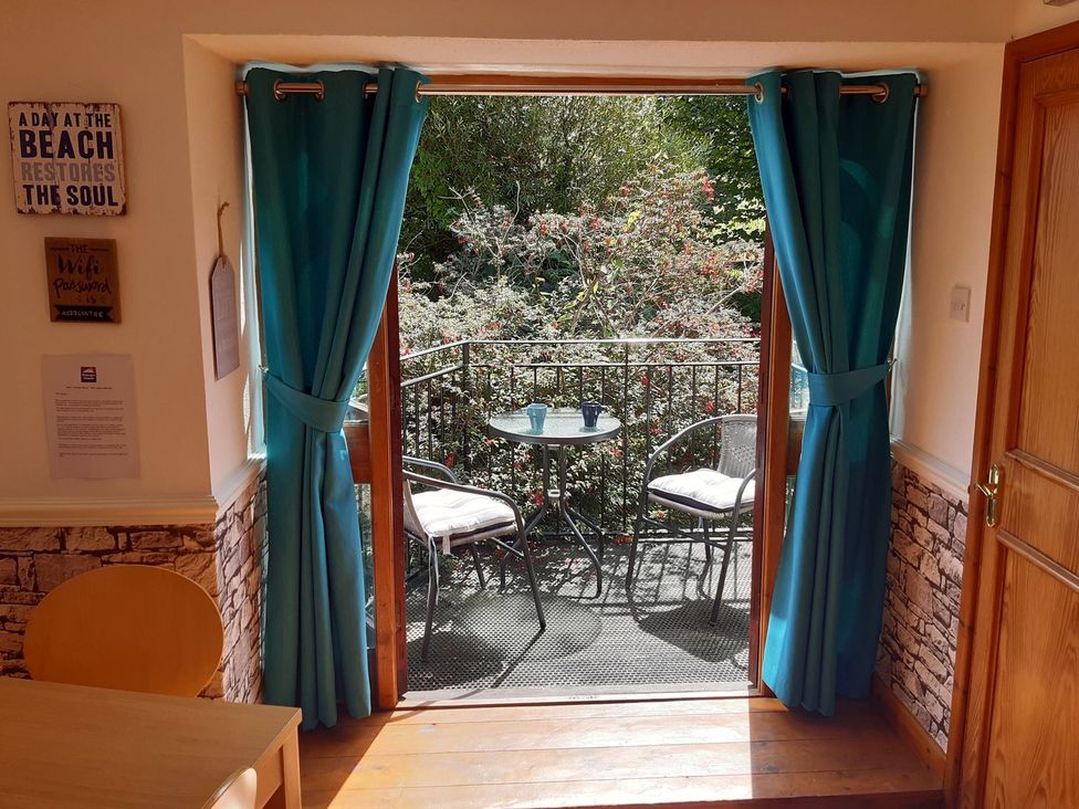 A balcony with table and chairs at Mill House Barn
