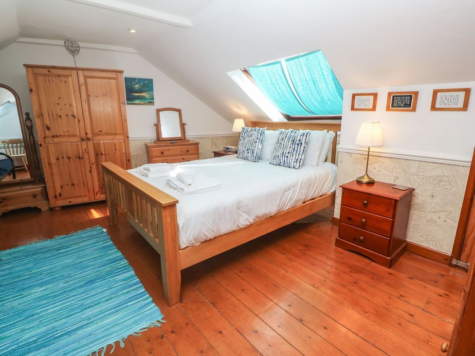 A bedroom with a bed and wardrobe at Mill House Barn