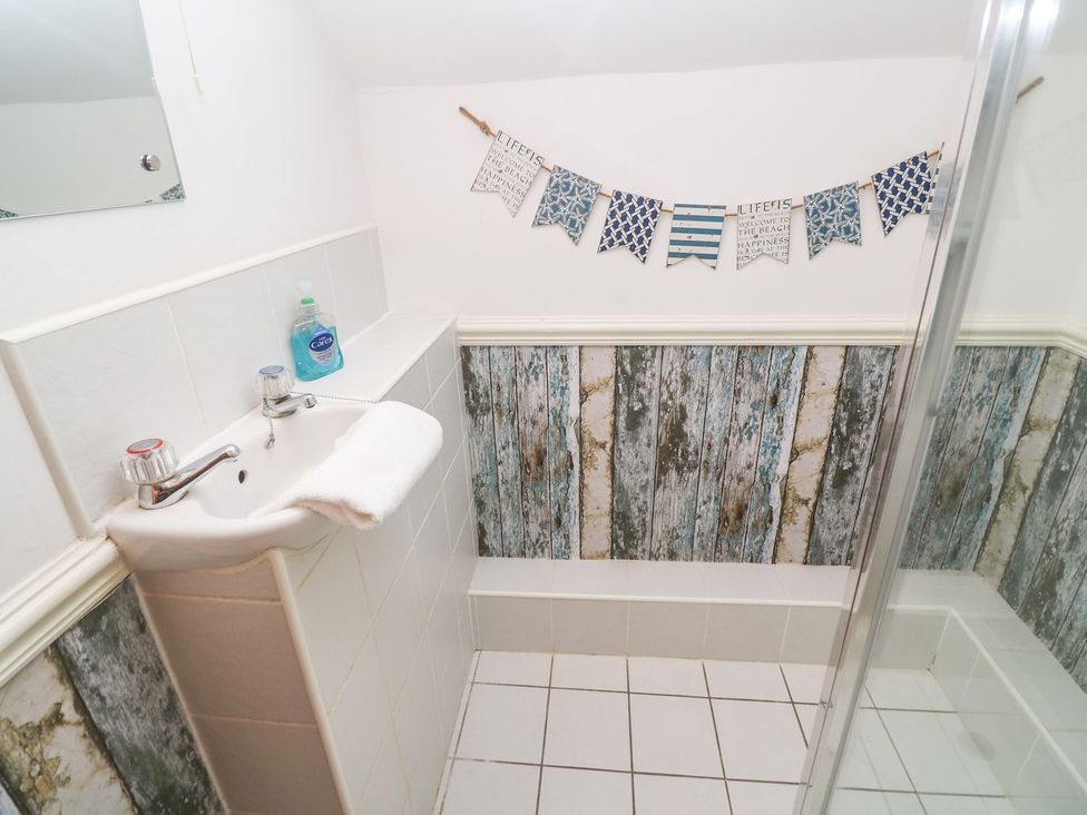 A bathroom with a sink and shower at Mill House Barn